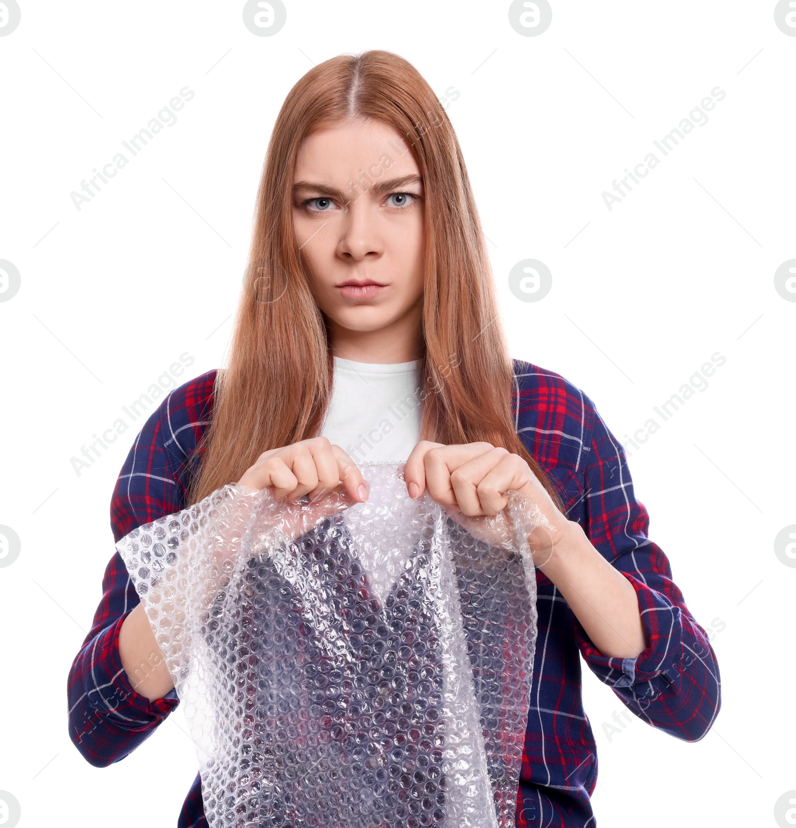 Photo of Angry woman popping bubble wrap on white background. Stress relief