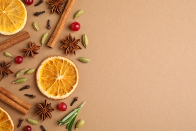 Photo of Different mulled wine ingredients on brown background, flat lay. Space for text