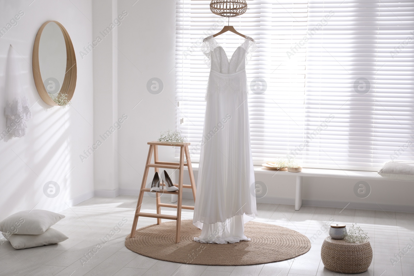 Photo of Beautiful wedding dress, shoes and flowers in room