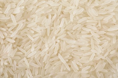 Photo of Raw long grain rice as background, top view