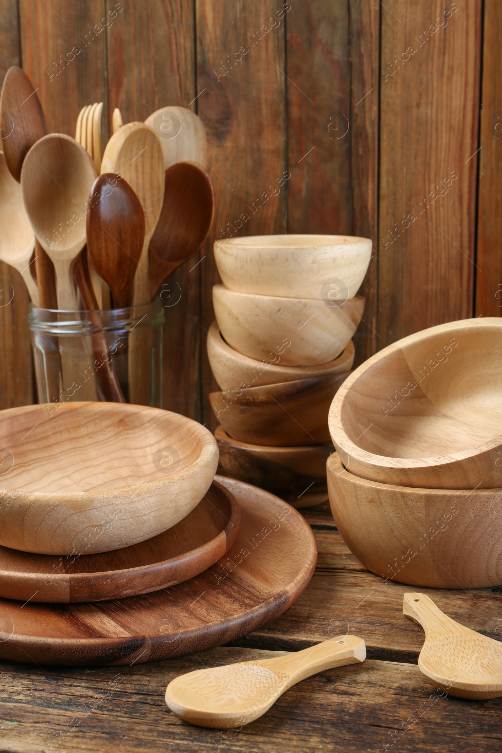 Photo of Many different wooden dishware and utensils on table