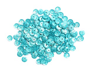 Photo of Pile of turquoise sequins on white background, top view