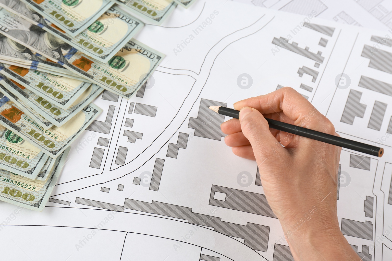 Photo of Cartographer with money drawing cadastral map, closeup