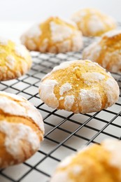 Photo of Tasty homemade lemon cookies on cooling rack, closeup