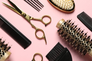 Photo of Professional hair dresser tools on pink background, flat lay