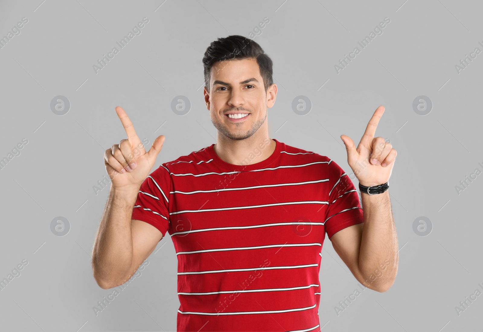 Photo of Man showing number four with his hands on grey background