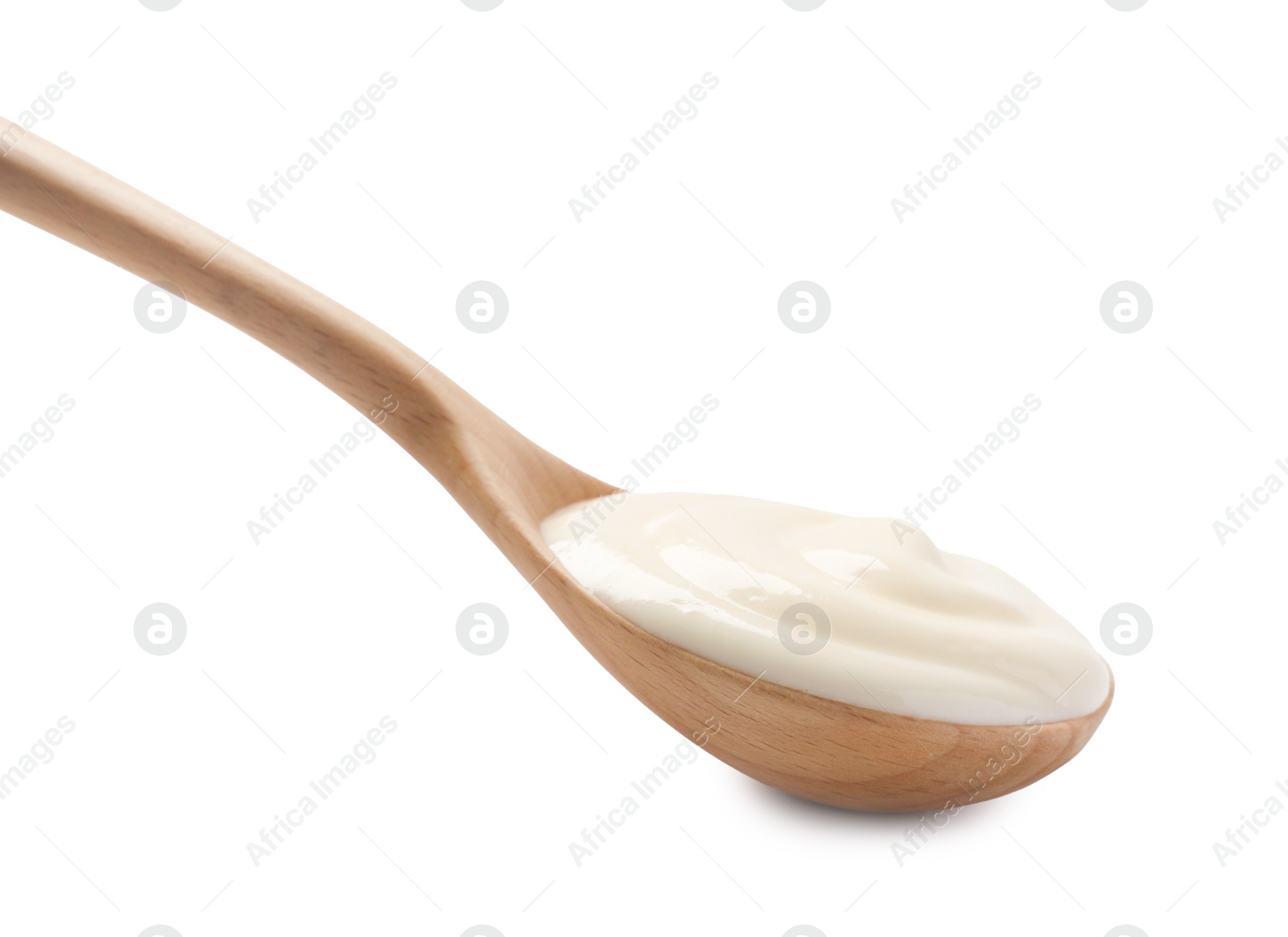 Photo of Natural yogurt in wooden spoon isolated on white