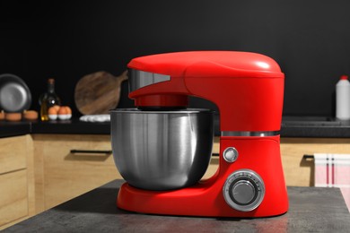 Photo of Modern stand mixer on grey table in kitchen