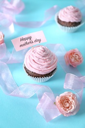 Photo of Festive surprise with tasty treat for Mother's Day on color background