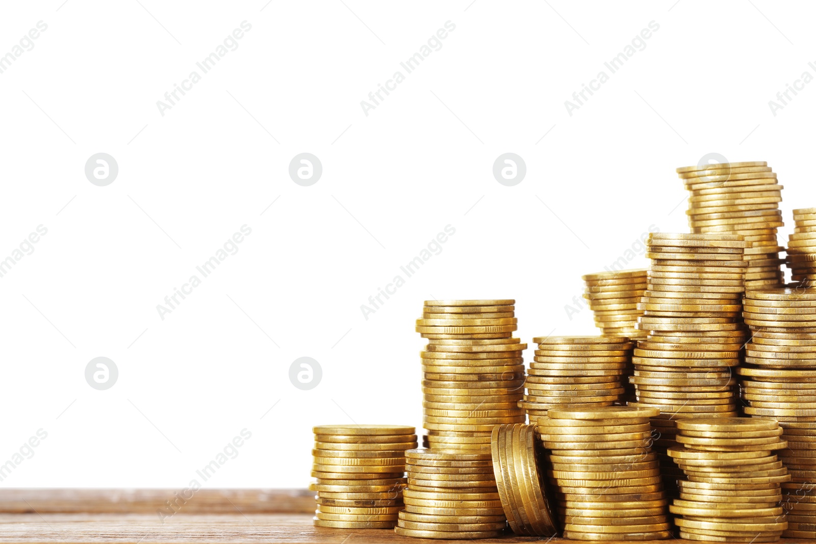 Photo of Stack of coins on wooden table, closeup. Space for text