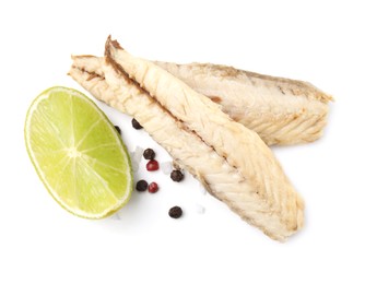 Photo of Canned mackerel fillets with lime and spices on white background