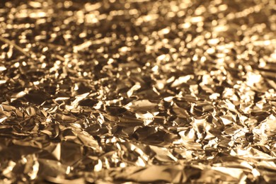 Crumpled gold foil as background, closeup view