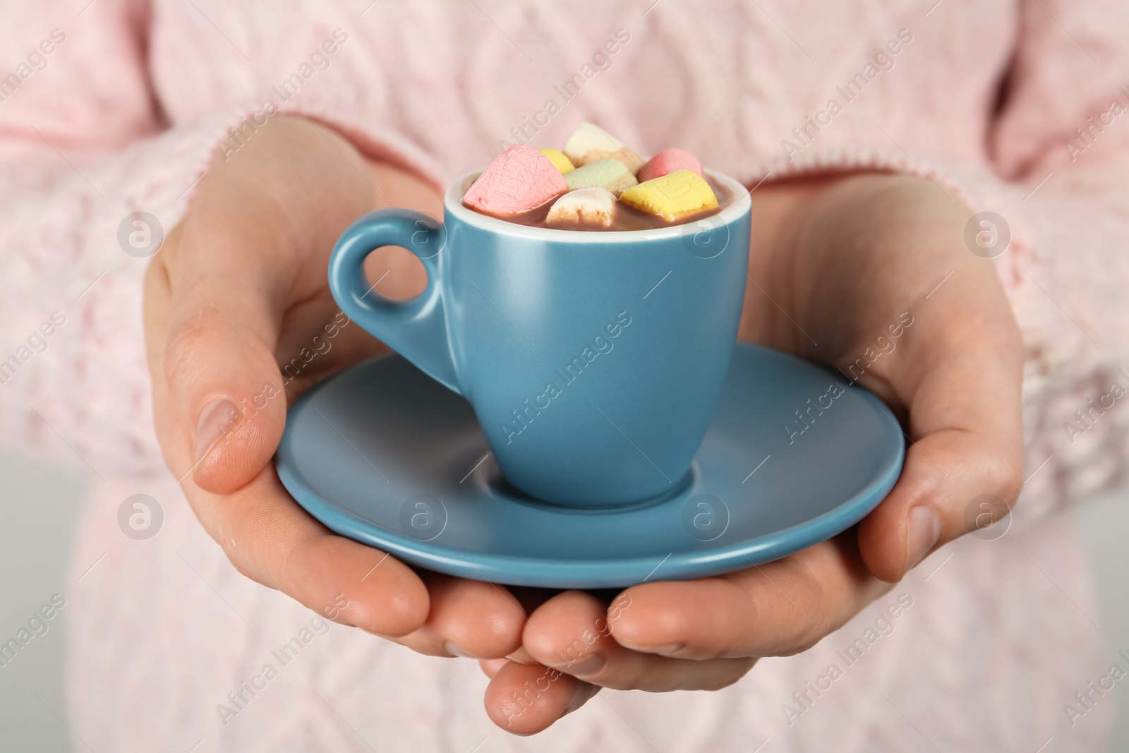 Photo of Woman holding cup of delicious hot chocolate with marshmallows, closeup