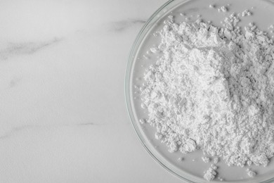 Photo of Petri dishes with calcium carbonate powder on white marble table, closeup. Space for text