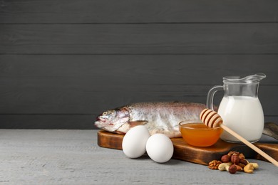 Photo of Allergenic food. Different fresh products on light gray wooden table, space for text