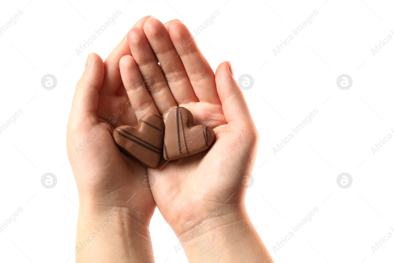 Photo of Woman holding heart shaped chocolate candies on white background, closeup