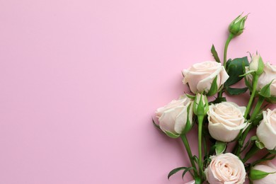 Beautiful bouquet of white roses on light pink background, flat lay. Space for text