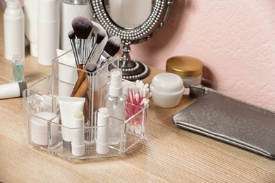 Photo of Set of body care cosmetic products on dressing table. Space for text