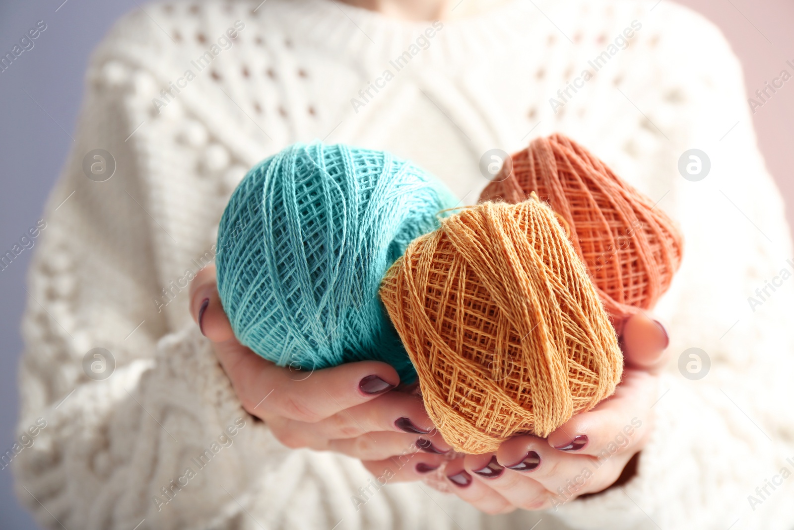 Photo of Woman holding clews of knitting threads, closeup