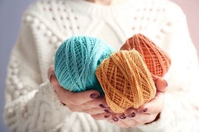 Photo of Woman holding clews of knitting threads, closeup