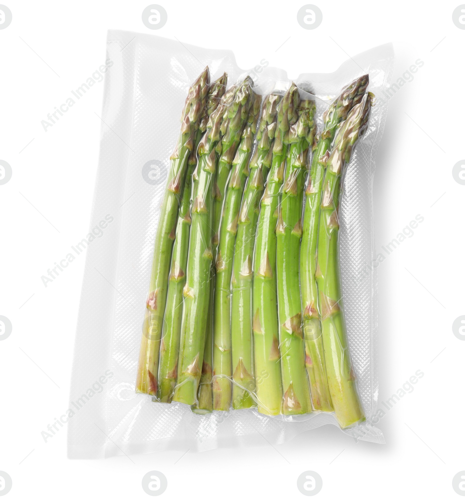 Photo of Vacuum pack of asparagus isolated on white, top view