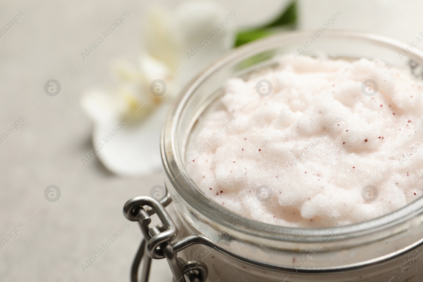 Photo of Body scrub in glass jar, closeup view