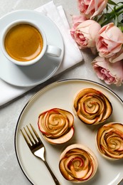 Photo of Freshly baked apple roses served on light table, flat lay. Beautiful dessert