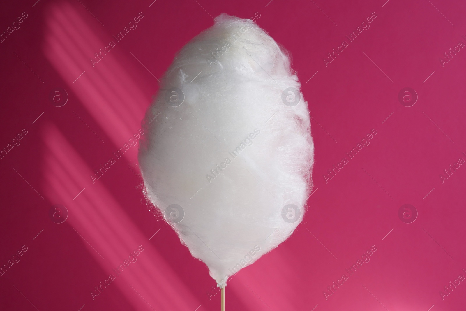 Photo of One sweet cotton candy on pink background