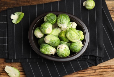 Fresh Brussels sprouts on wooden table, flat lay