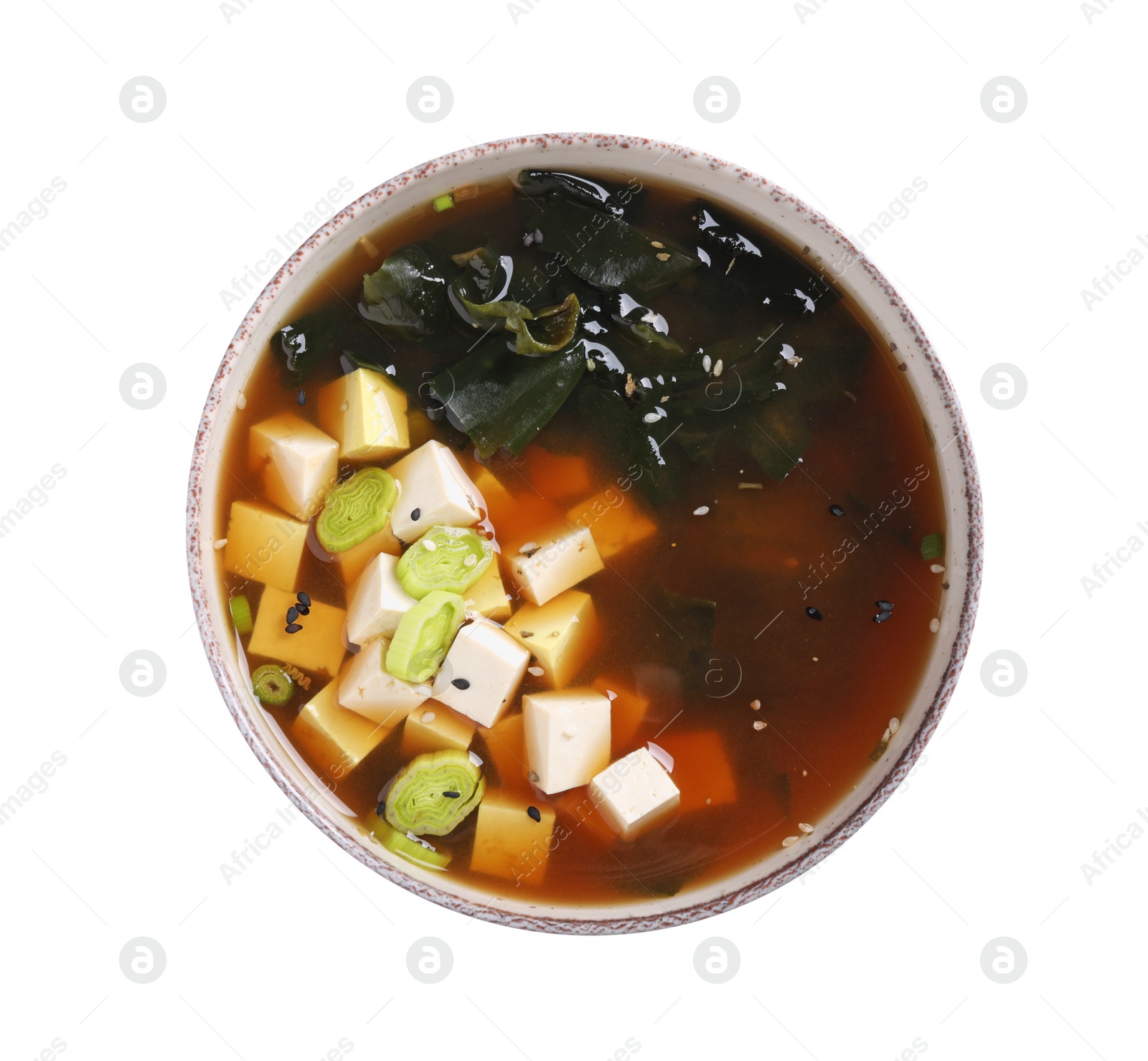 Photo of Bowl of delicious miso soup with tofu isolated on white, top view