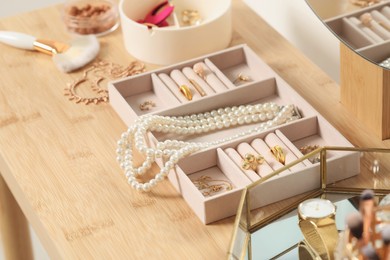 Photo of Jewelry boxes with many different accessories on wooden table