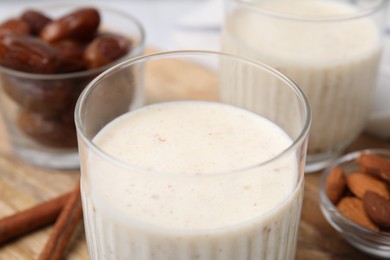 Photo of Glasses of delicious date smoothie on table, closeup