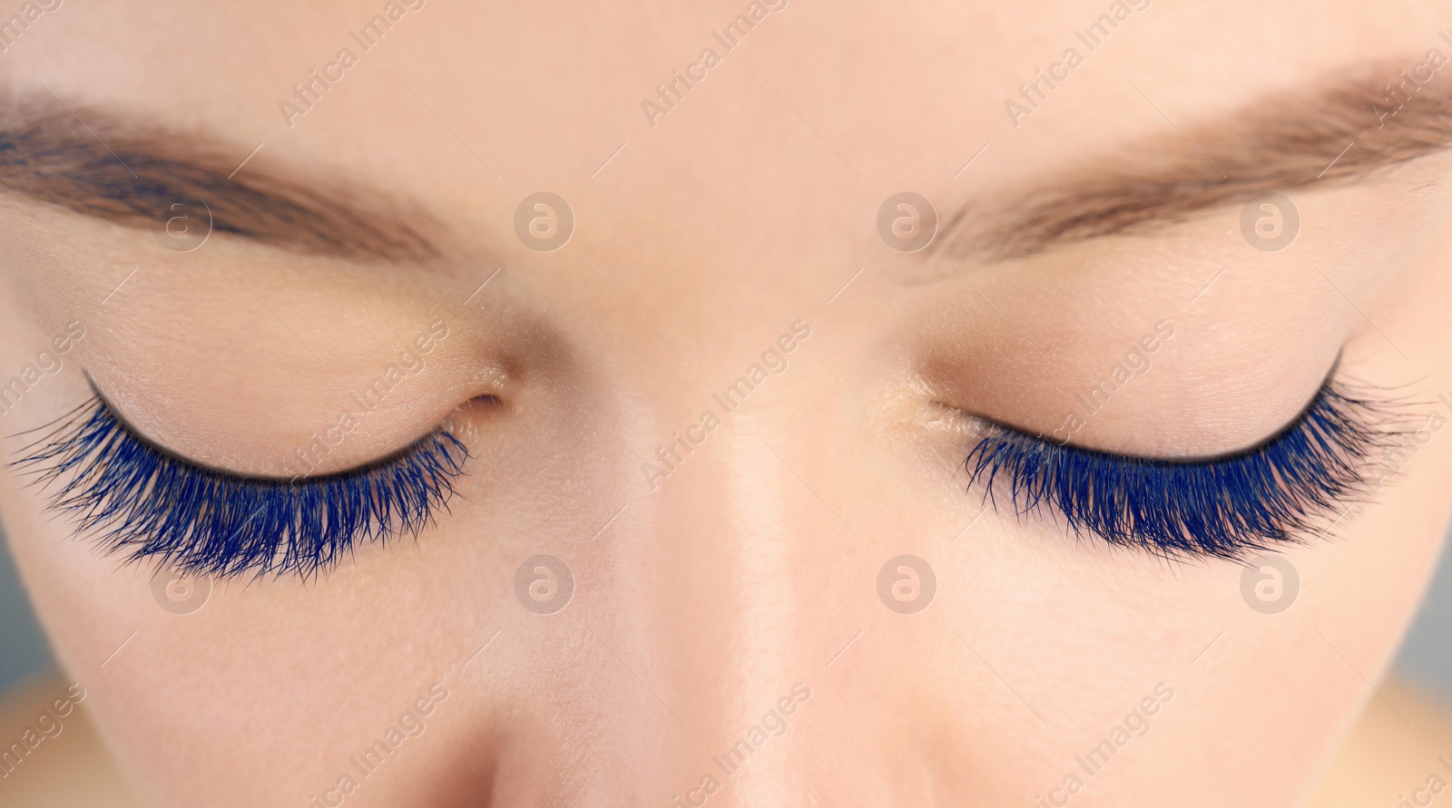 Image of Young woman with beautiful blue eyelashes, closeup