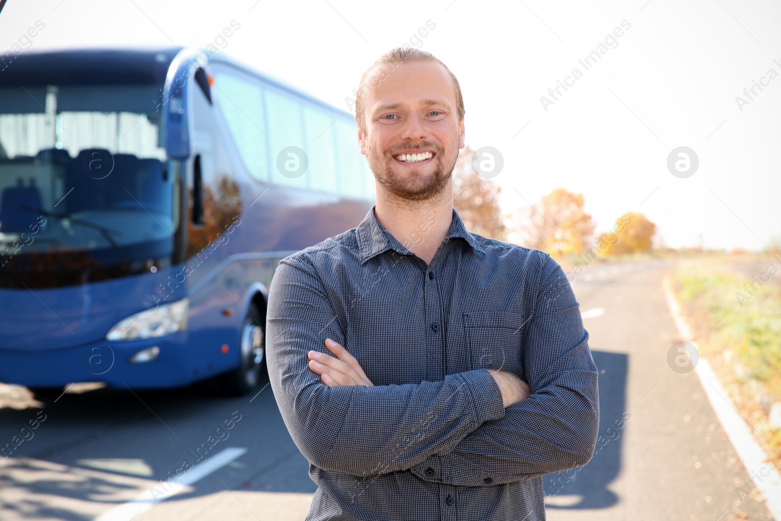 Photo of Professional driver standing near bus. Passenger transportation