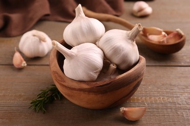 Photo of Fresh garlic on wooden table, closeup view