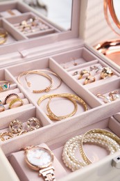 Photo of Jewelry box with stylish golden bijouterie, closeup view