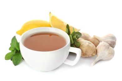 Photo of Cup of tea, ginger, garlic, mint and lemons on white background. Cough remedies