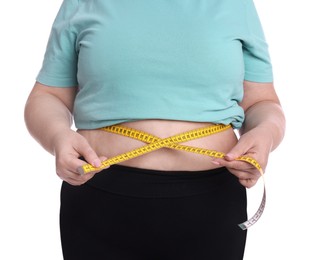 Photo of Overweight woman measuring waist with tape on white background, closeup