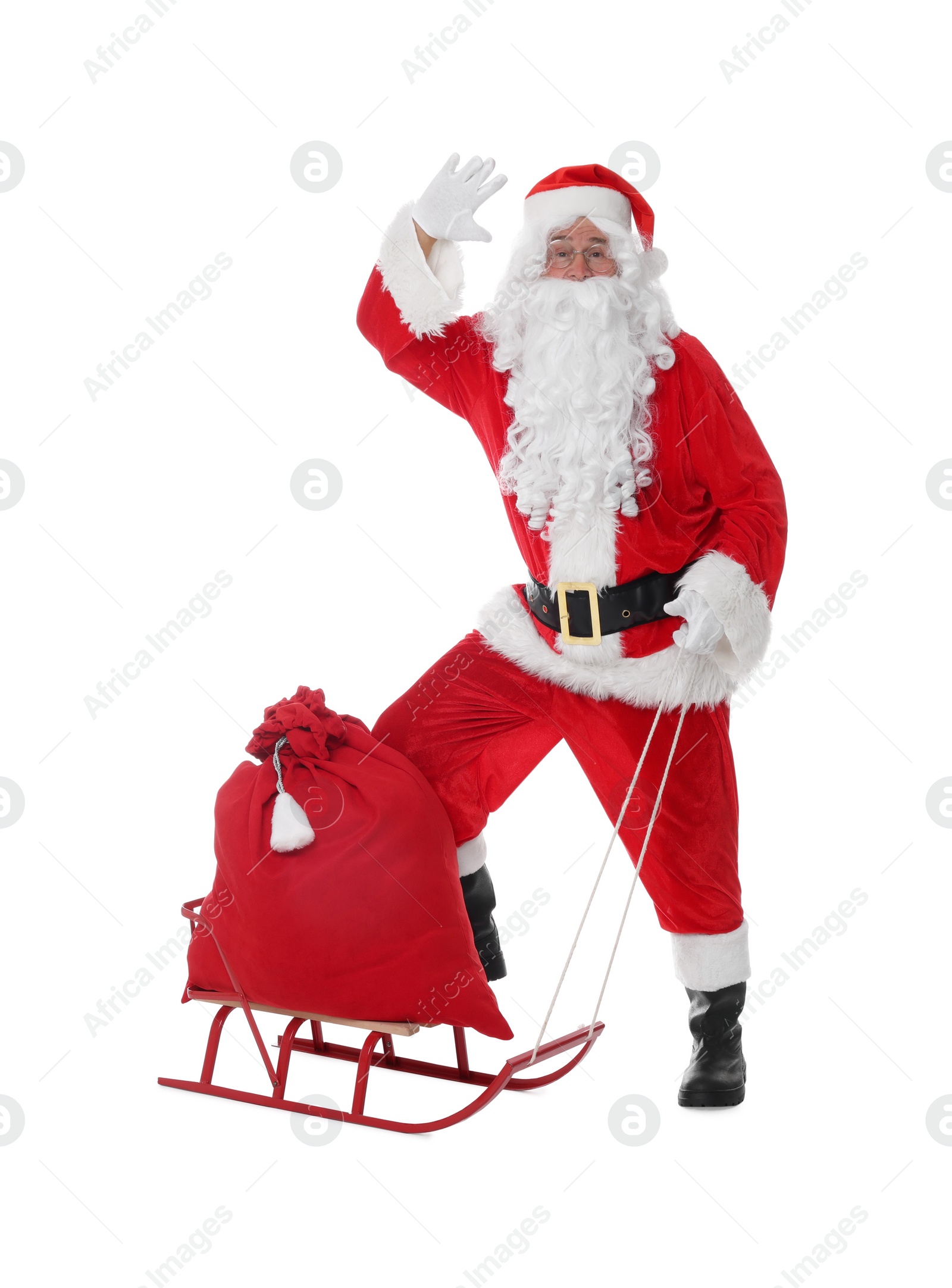 Photo of Man in Santa Claus costume with bag and sleigh on white background