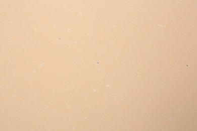 Photo of Texture of beige paper sheet as background, top view