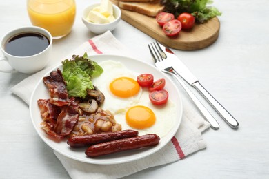Delicious breakfast with sunny side up eggs served on white table