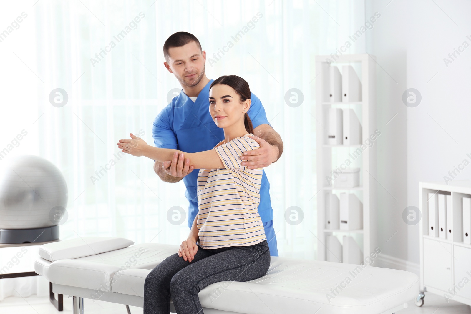 Photo of Doctor working with patient in hospital. Rehabilitation physiotherapy