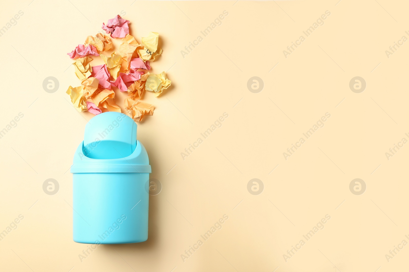 Photo of Trash bin and different garbage on color background, top view with space for text. Waste recycling concept