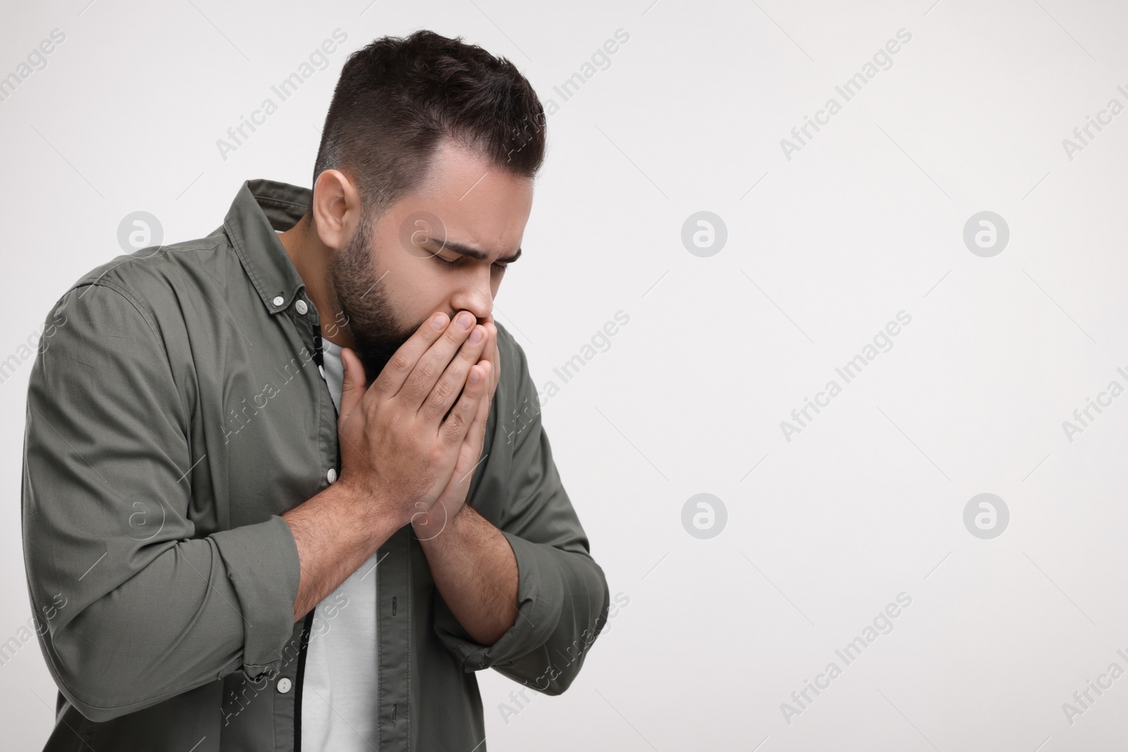 Photo of Sick man coughing on white background, space for text