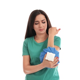 Photo of Woman with cold compress suffering from elbow pain on white background