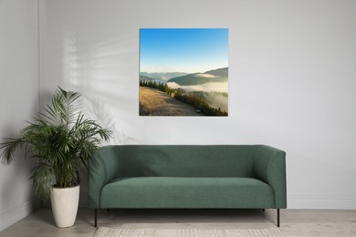 Image of Canvas with printed photo of mountain landscape on white wall in living room