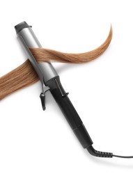 Photo of Curling iron with hair lock on white background, top view