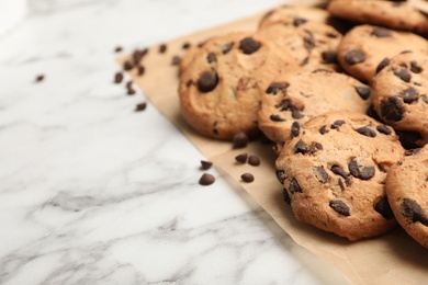 Photo of Tasty chocolate cookies on marble table, closeup