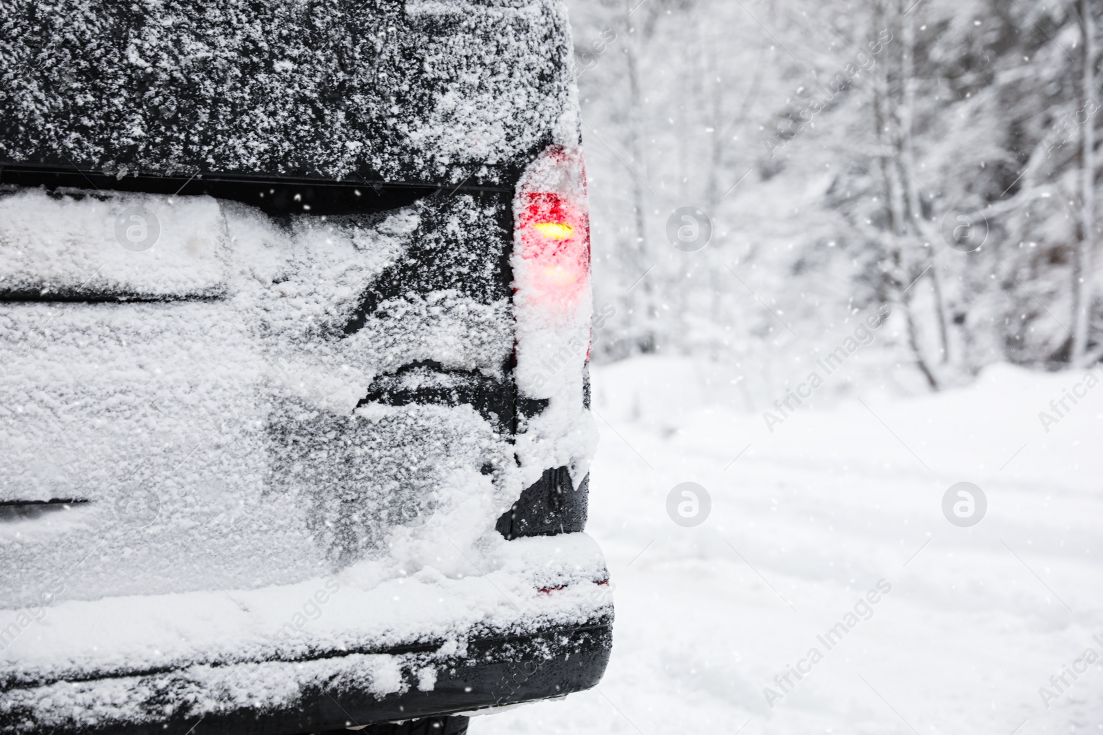 Photo of Closeup view of car on snowy country road