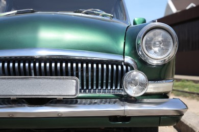 Photo of Beautiful green retro car on street, closeup